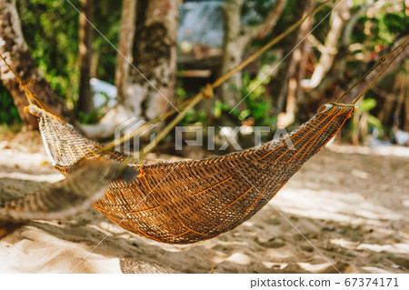 a handmade hammock on the beach during summer holiday 67374171
