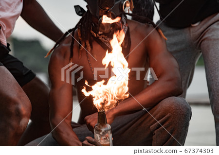 black american demonstrators set fire on bottles with cloth 67374303