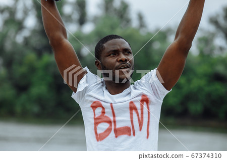 young black man in t-shirt with BLM inscription 67374310