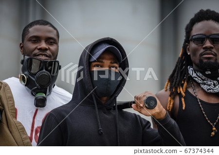portrait of armed black men in the streets 67374344