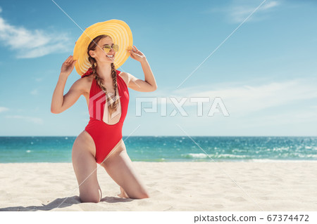 Woman in her beach vacation with ocean in the background 67374472