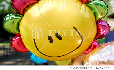 Yellow balloon with smile look like sunny 67374560