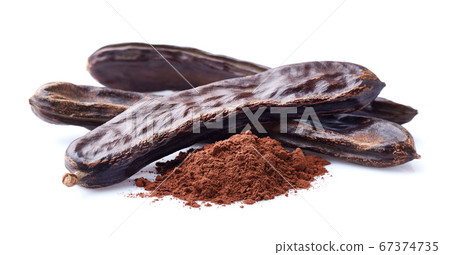 Carobs pod with powder in closeup on white Carobs pod with powder in closeup on white 67374735