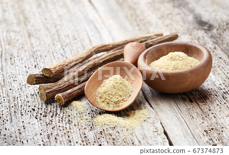 Licorice powder with dry roots on wooden 67374873