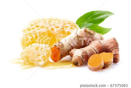 Honeycombs with turmeric root on white Honeycombs with turmeric root on white 67375065