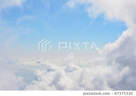 A clear blue sky in the summer, with a glimpse of the fluffy waves of the sea of clouds at the summit of Chogagatake in the Northern Alps. Fluffy cloud tunnel. A clear blue sky in the summer, with a glimpse of the fluffy waves of the sea of clouds at the summit of Chogagatake in the Northern Alps. Fluffy cloud tunnel. 67375330