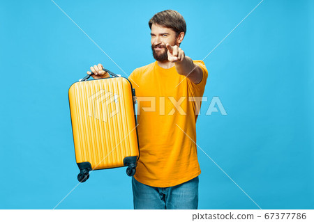 handsome man shows his finger to the camera on a blue background handsome man shows his finger to the camera on a blue background 67377786