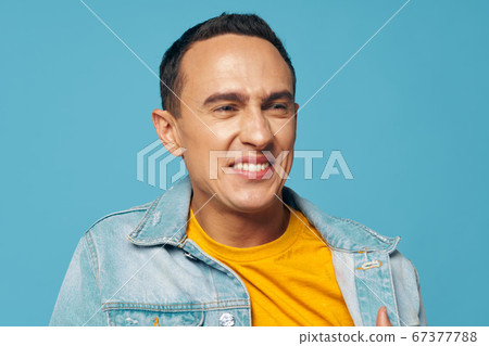 Emotional man smiles and a yellow shirt denim Emotional man smiles and a yellow shirt denim 67377788