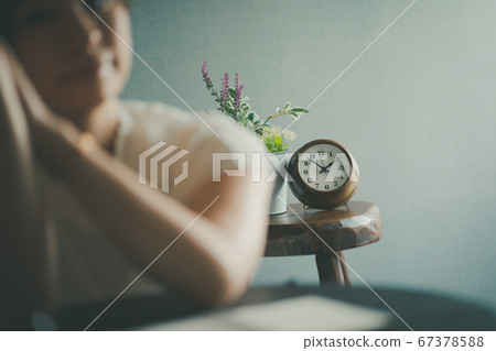 A woman sitting late at night A woman sitting late at night 67378588