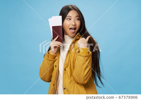 woman with tickets and passport shows a positive gesture woman with tickets and passport shows a positive gesture 67378906