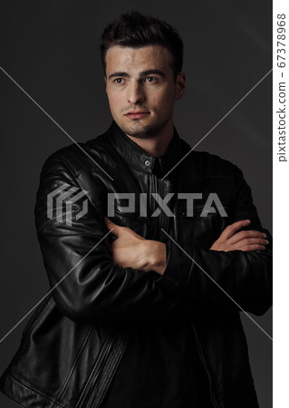man crossed his arms over his chest and look away 67378968