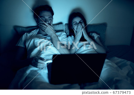 happy man and woman looking at a laptop and laughing happy man and woman looking at a laptop and laughing 67379473