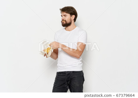 A man in a T-shirt and pants with potatoes A man in a T-shirt and pants with potatoes 67379664