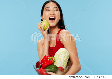 Happy dieting woman with groceries in hand smiling Happy dieting woman with groceries in hand smiling 67379665