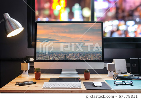 Graphic designer's workspace with city night view Graphic designer's workspace with city night view 67379811