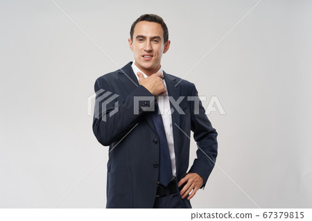 confident businessman adjusting shirt collar finance model 67379815