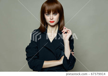 Strict look of a beautiful brunette woman in a black coat free place Strict look of a beautiful brunette woman in a black coat free place 67379914