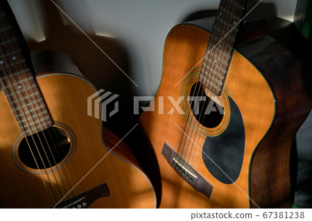 Two classical guitars by the wall 67381238