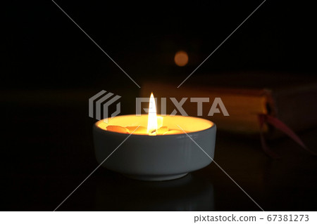 Candlelight with holy bible at the background. Candlelight with holy bible at the background. 67381273