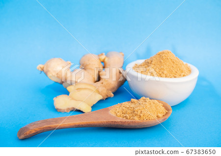 Ginger fresh and ginger powder on blue background. concept healthy spice diet Ginger fresh and ginger powder on blue background. concept healthy spice diet 67383650