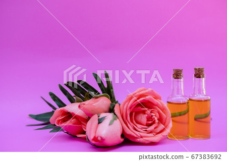Essential oil in bottles extracted from rose 67383692