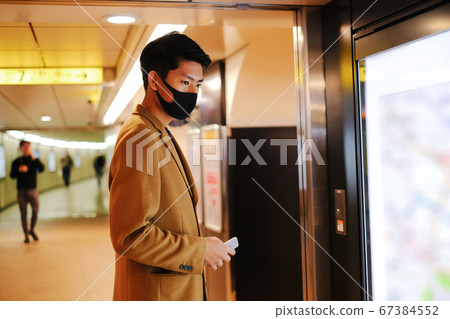 Asian man searching the city on LCD display for travel 67384552