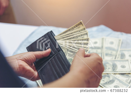 Hand holding money dollar bank note in wallet give 67388232