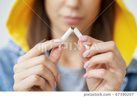 Stop smoking, close up of woman breaking cigarette Stop smoking, close up of woman breaking cigarette 67390207