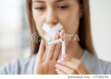 Stop smoking, close up of woman breaking cigarette Stop smoking, close up of woman breaking cigarette 67390244