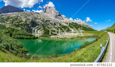 Glacial lake with clear cold water. Lago di Fedaia, Dolomites Glacial lake with clear cold water. Lago di Fedaia, Dolomites 67392122