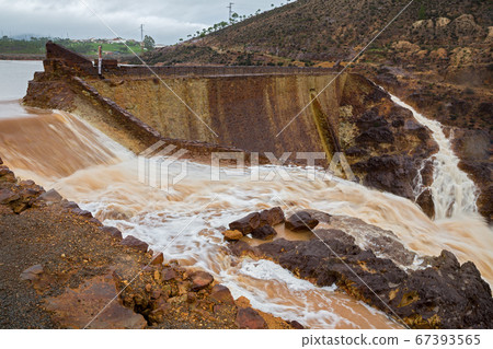 Dam and flood, top view on a cloudy day 67393565