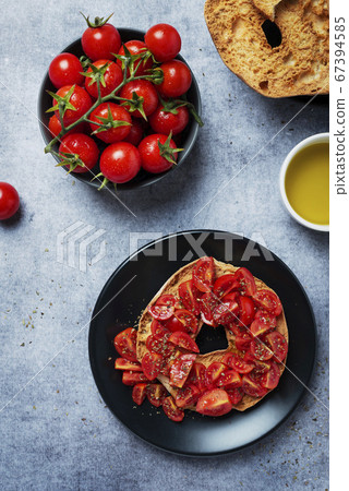 Friselle with tomato, oil and origano Friselle with tomato, oil and origano 67394585