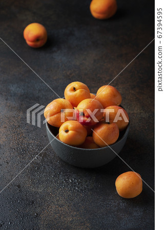 sweet apricots in a dark background sweet apricots in a dark background 67394595