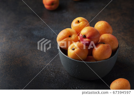 sweet apricots in a dark background sweet apricots in a dark background 67394597