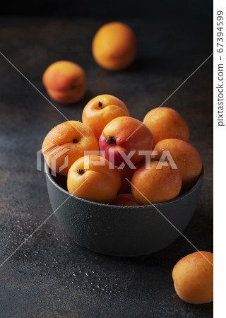 sweet apricots in a dark background sweet apricots in a dark background 67394599