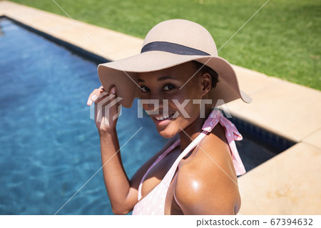 Portrait of smiling woman wearing hat Portrait of smiling woman wearing hat 67394632