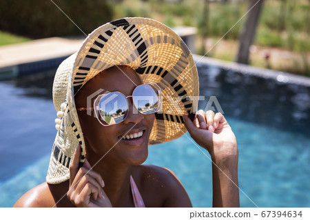 Woman wearing hat and sunglasses Woman wearing hat and sunglasses 67394634