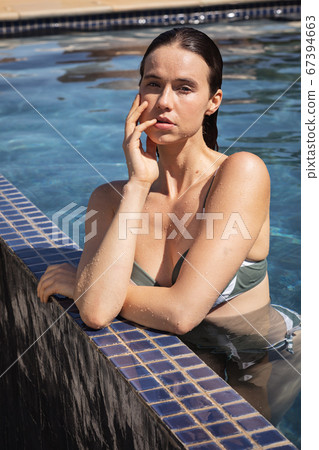 Portrait of woman in the pool 67394663