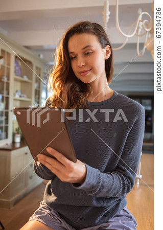 Woman using digital tablet at home Woman using digital tablet at home 67394786