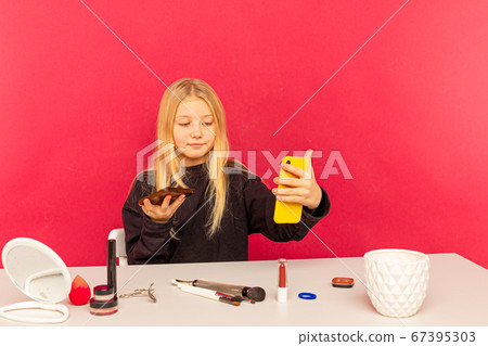 Girl beauty blogger. Blond teen posing on camera and making vlog. 67395303
