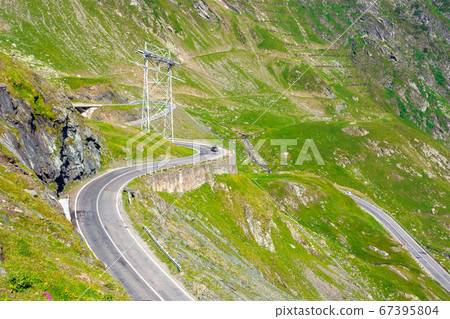 winding mountain road on a sunny day. empty winding mountain road on a sunny day. empty 67395804