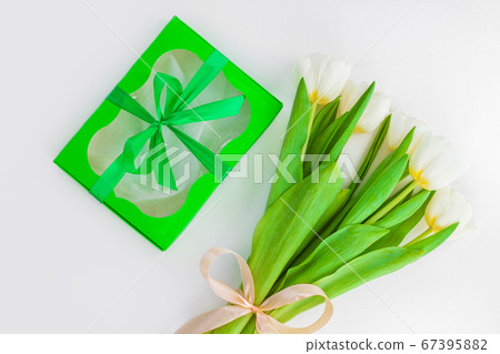 White tulip flowers and black gift box on light 67395882