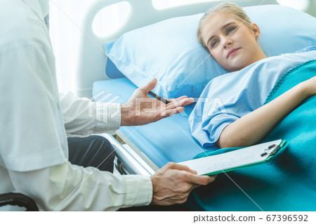 Doctor in professional uniform examining patient at hospital 67396592
