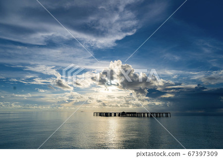 A mid-construction foundation floating in the Maldives Sea at sunset 67397309