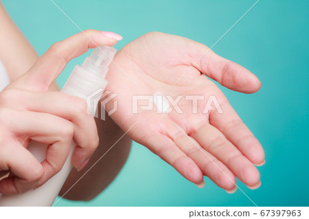 Woman putting white cream on hand Woman putting white cream on hand 67397963