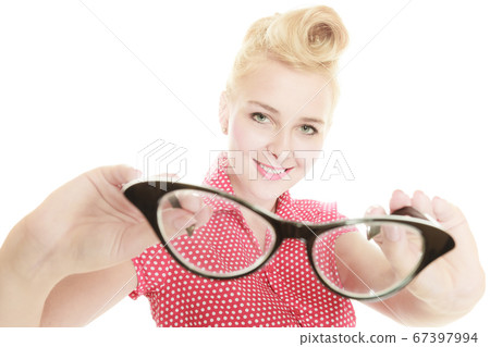 Blonde pin up girl holding retro glasses Blonde pin up girl holding retro glasses 67397994