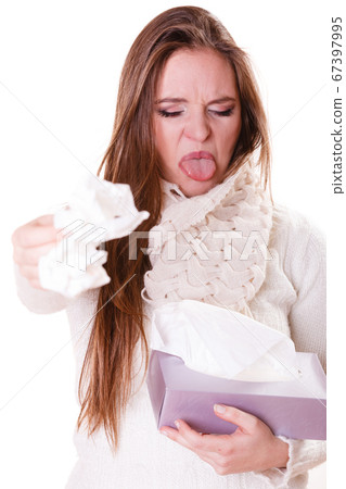 Sick woman girl with fever sneezing in tissue Sick woman girl with fever sneezing in tissue 67397995