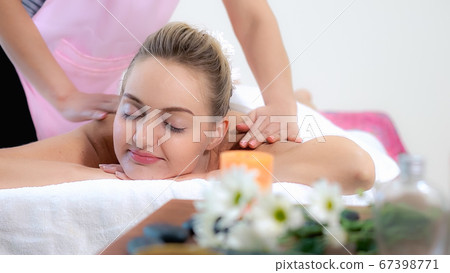 Woman gets back massage spa by massage therapist. Woman gets back massage spa by massage therapist. 67398771