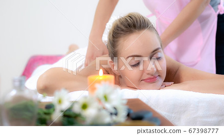 Woman gets back massage spa by massage therapist. Woman gets back massage spa by massage therapist. 67398777