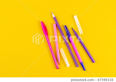 Set of colored pens on yellow paper background with copy space. 67399138